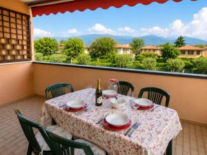 a table on a balcony with a view of the mountains at Residence The Yellow Fish with Pool in Manerba del Garda