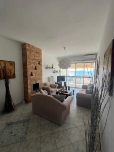 a living room with two couches and a fireplace at Paradise House in Lefkandi Chalkidas