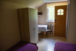 a room with a door and a table and a window at Willa Świerk in Susiec
