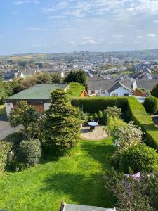 a garden with hedges and a view of a city at Belle-Vue in Truro +4 photos