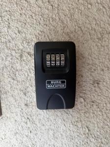 a black remote control sitting on a carpet at Апартамент Кари in Yambol