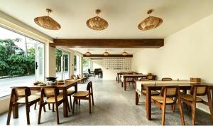 a dining room with tables and chairs and large windows at Book NOW & Chat, Wake in Mountain,Free Shuttle,Aside National Park, Combo Stay in Tianmen city center, English Speaking Assistant in Jiawan