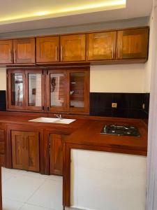 a kitchen with wooden cabinets and a sink at Villa REEL in Morondava
