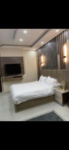 a bedroom with a large bed and a flat screen tv at Tetou Hotel Cairo in Cairo +4 photos