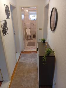 a hallway with a bathroom with a toilet and a mirror at Apartman Čeliković centar Šamca, parking, balkon, WiFi in Bosanski Šamac +41 photos