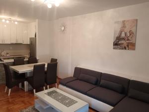 a living room with a couch and a table at Apartman Vuk in Ćuprija