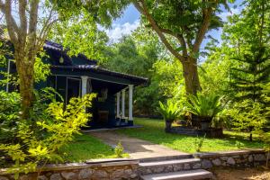 a house in the woods with trees at Sigiri Siesta Homestay in Sigiriya