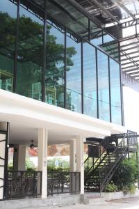 a large glass building with stairs in front of it at Tambun Inn Hotel in Ipoh