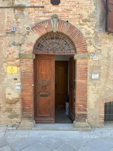 an entrance to a brick building with a wooden door at Principessa in Panicale