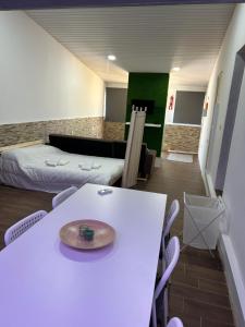 a room with a white table and a bed and a room with a bed at Sky carvoeiro in Mação +4 photos