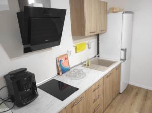 a kitchen with a counter with a tv on the wall at Sleeping house in Cluj-Napoca