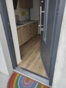 an open door to a kitchen with a wooden floor at Sleeping house in Cluj-Napoca