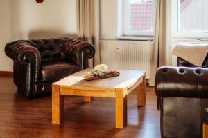 a living room with a coffee table and a couch at Bergpanorama in Sankt Andreasberg