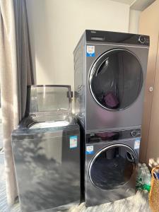 a washer and a dryer next to a washing machine at Book NOW & Chat, Wake in Mountain,Free Shuttle,Aside National Park, Combo Stay in Tianmen city center, English Speaking Assistant in Jiawan