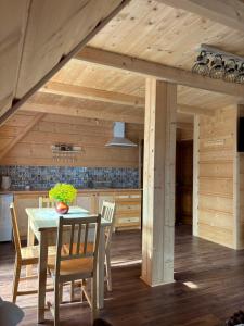 a kitchen and dining room with a table and chairs at Pokoje goscinne u Jozka in Chochołów