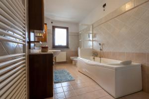 a bathroom with a tub and a toilet and a sink at ROSSO DI SERA Bed & Breakfast in Tarcento