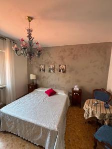 a bedroom with a bed and a chandelier at Viola Apartment Monte Felice in Bardolino