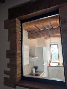 a view of a kitchen through a window at Principessa in Panicale +14 photos