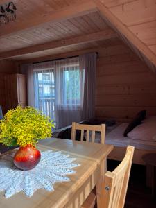 a room with a wooden table and a bedroom at Pokoje goscinne u Jozka in Chochołów +61 photos