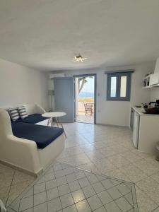 a living room with a couch and a table at Christos rooms milos in Adamantas +51 photos