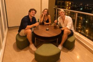 a group of three people sitting around a table at 2BHK Luxurious Apt near BKC in Mumbai
