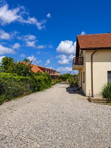 a gravel road in front of a building at Casa KariAna in Murighiol