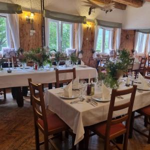 a dining room with white tables and chairs at Great Mountain B&B Platak in Platak