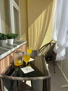 a table with two glasses of wine on a balcony at AeraSuites Komárom in Komárom