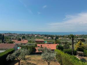 a view of a town with trees and buildings at Viola Apartment Monte Felice in Bardolino