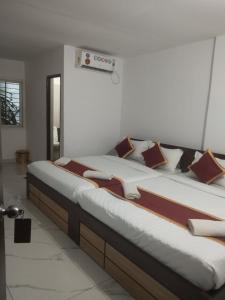 two large beds in a room with at SLV Royal Residency Hotel in Bidadi