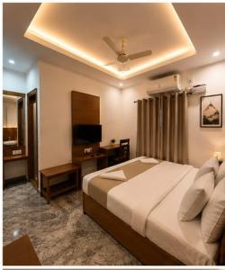 a bedroom with a large bed with a ceiling at Hotel bella rosa in Chengalpattu