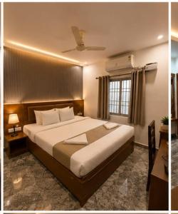 a bedroom with a large bed and a window at Hotel bella rosa in Chengalpattu
