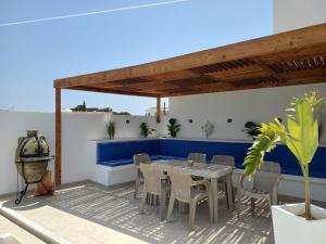 a patio with a table and chairs on a roof at Dar Aalya in Djerba