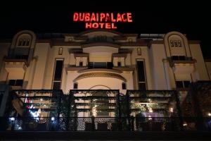 a large building with a sign that reads dinosaur palace hotel at Dubai Palace Hotel in Sambriāl