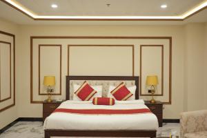 a bedroom with a large bed with red pillows at Dubai Palace Hotel in Sambriāl +46 photos
