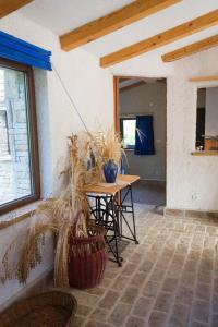 a room with a table and chairs and a window at ECO Beach Houses - Pet friendly in Peroj