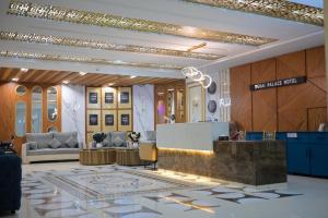 a lobby with a reception desk in a building at Dubai Palace Hotel in Sambriāl