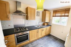 a kitchen with a sink and a stove top oven at The Rosewood in Grays Thurrock