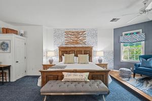 a bedroom with a large bed and a blue chair at Inn at the Park Bed and Breakfast in South Haven