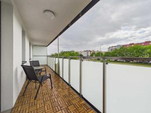 a balcony with a desk and a laptop on it at Apartament HUZAR 2 in Białystok