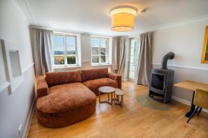 a living room with a couch and a wood stove at Erasmus WaldBlick Ferienhaus mit Ausblick in Saarburg