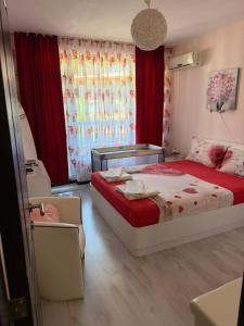 a bedroom with a bed and red curtains at Апартамент Green Lines in Primorsko +50 photos
