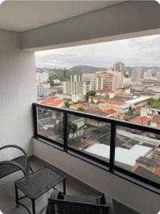 a balcony with a view of a city at Diamond - Flat Bela Estância in São Lourenço