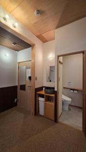 a bathroom with a toilet and a sink at Poly Hostel 2 Namba in Osaka +31 photos
