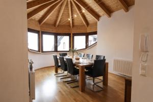 a dining room with a table and black chairs at Kelchalm Superior Spacious Mountain Apartment in Bad Kleinkirchheim