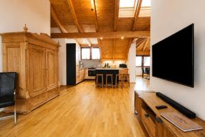 a large living room with a flat screen tv at Kelchalm Superior Spacious Mountain Apartment in Bad Kleinkirchheim