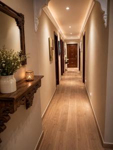 a hallway with wooden floors and a long hallway at El Rincón de Luarca in Luarca +1 photo