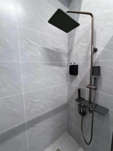 a shower with a shower head in a bathroom at Keruen in Almaty