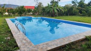 a swimming pool with blue water in a yard at Pucayacu Wasi in Sauce