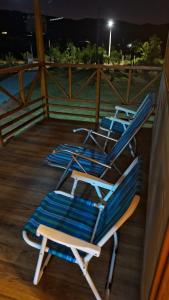 two lounge chairs sitting on a deck at night at Pucayacu Wasi in Sauce